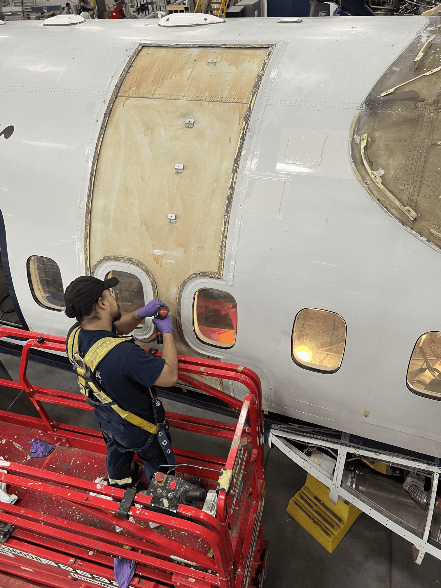Structural technician working on an aircraft